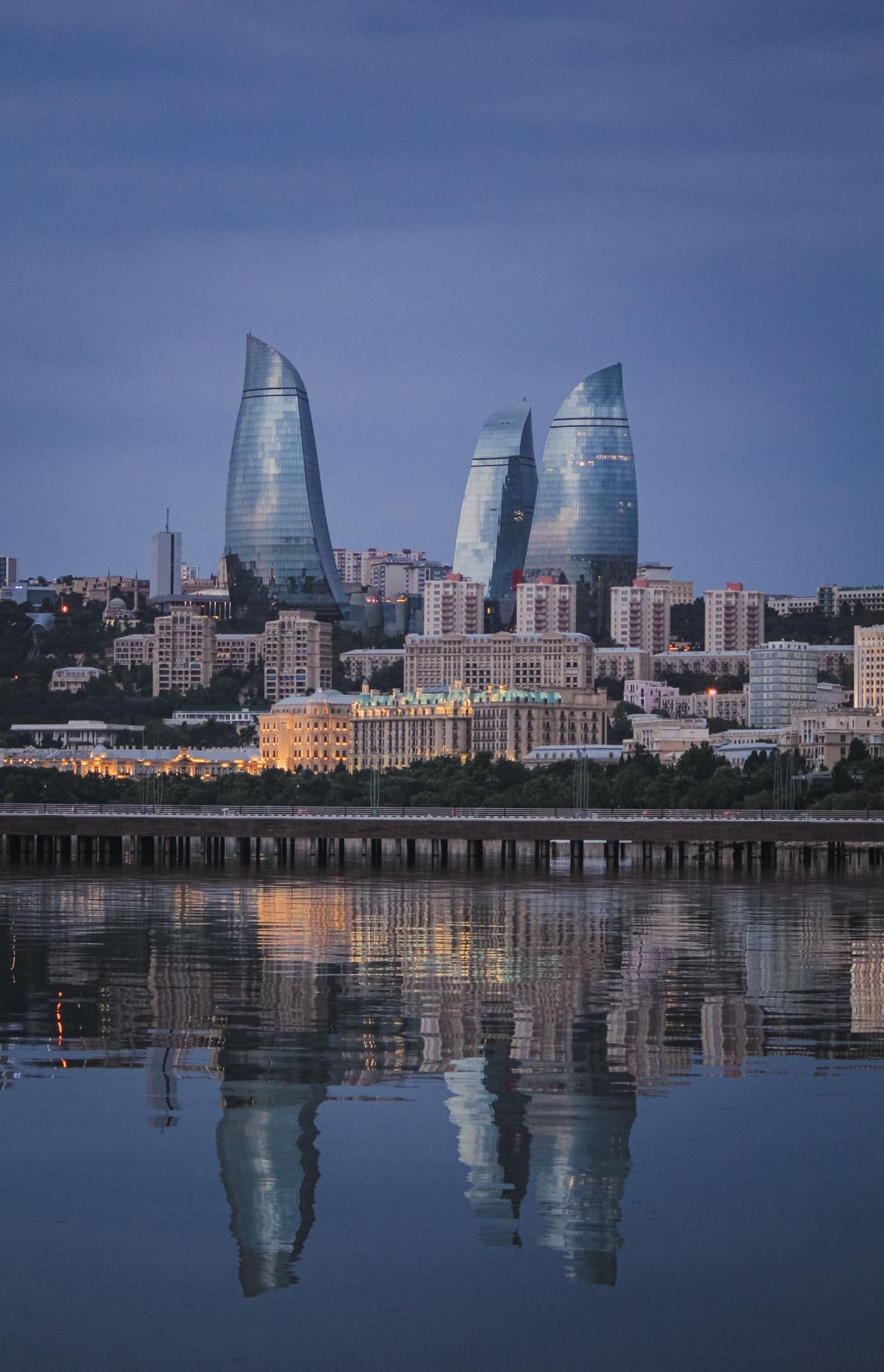 Baku's Flame Towers reflected in the Caspian Sea at dusk